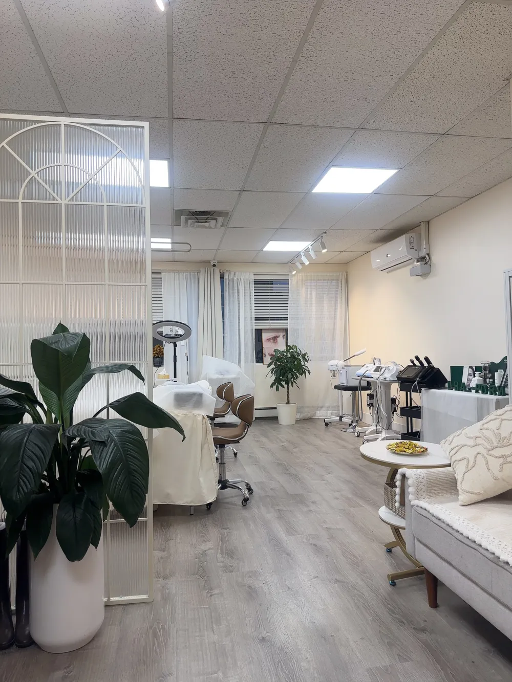 Bright, clean interior of the COCO Beauty Lash studio in Flushing with treatment beds and plants