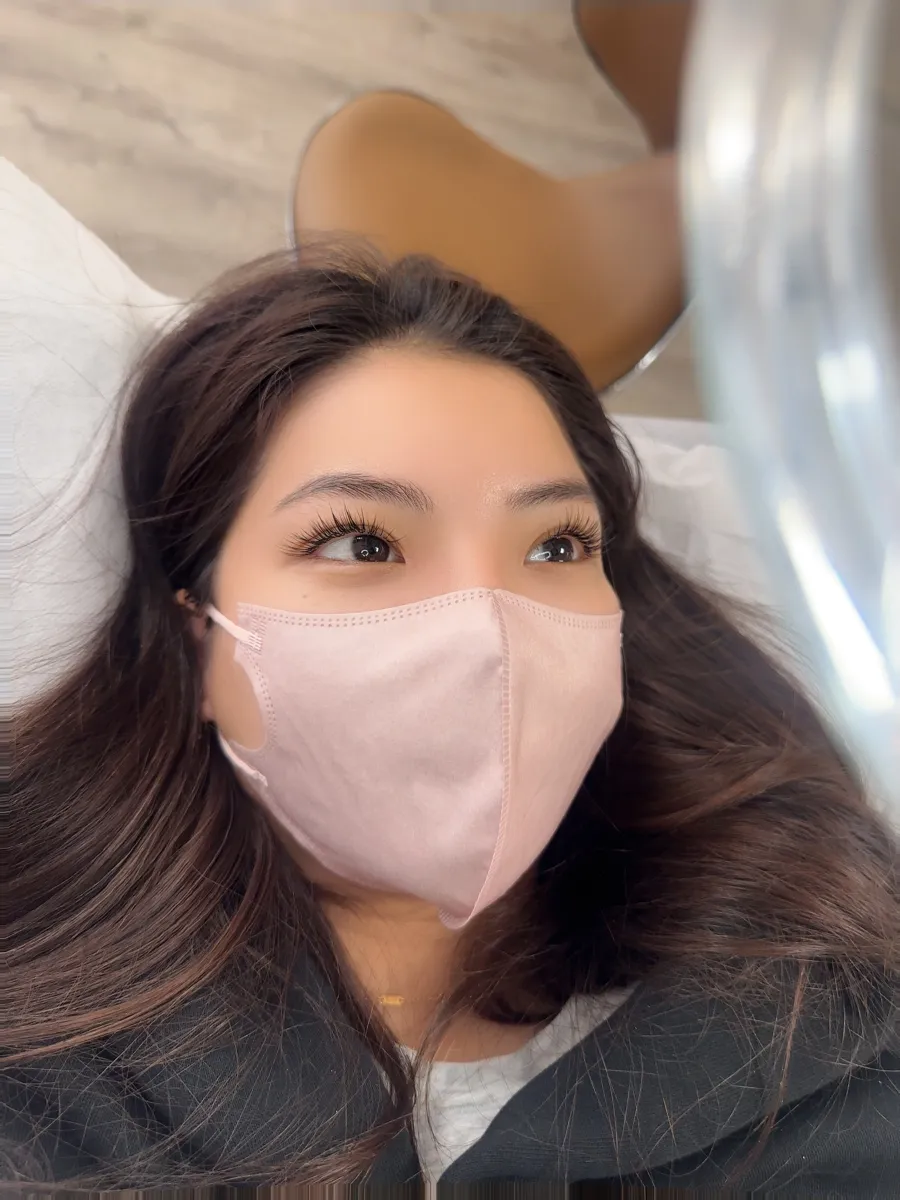 COCO Beauty Lash client showing her new lash extensions in the studio